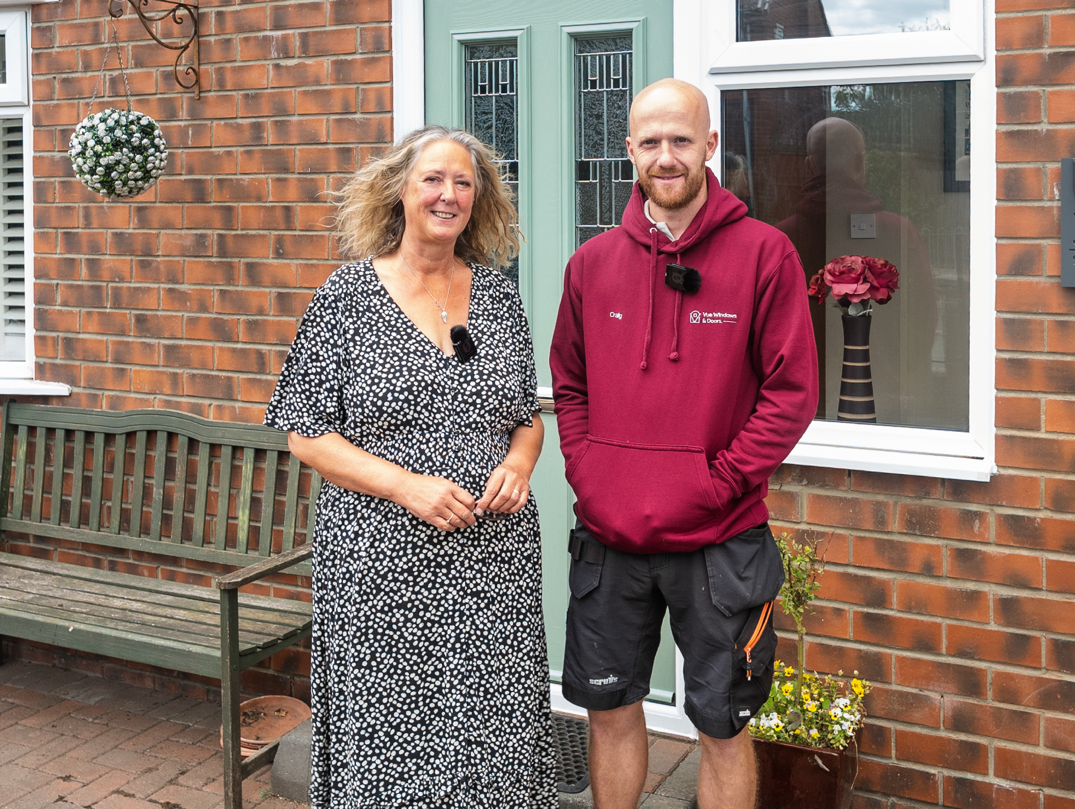 Vue Windows & Doors team members in front of a composite door installation