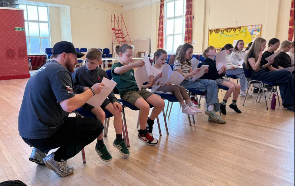 Instructor coaching students through a script reading