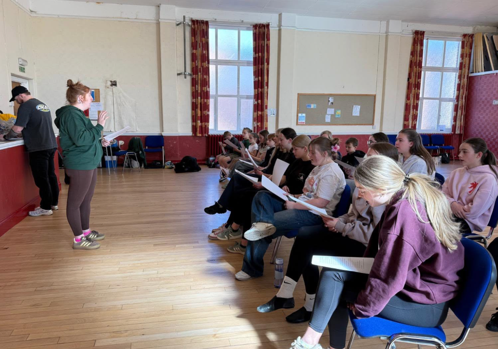 Spotlight students rehearsing with their instructor