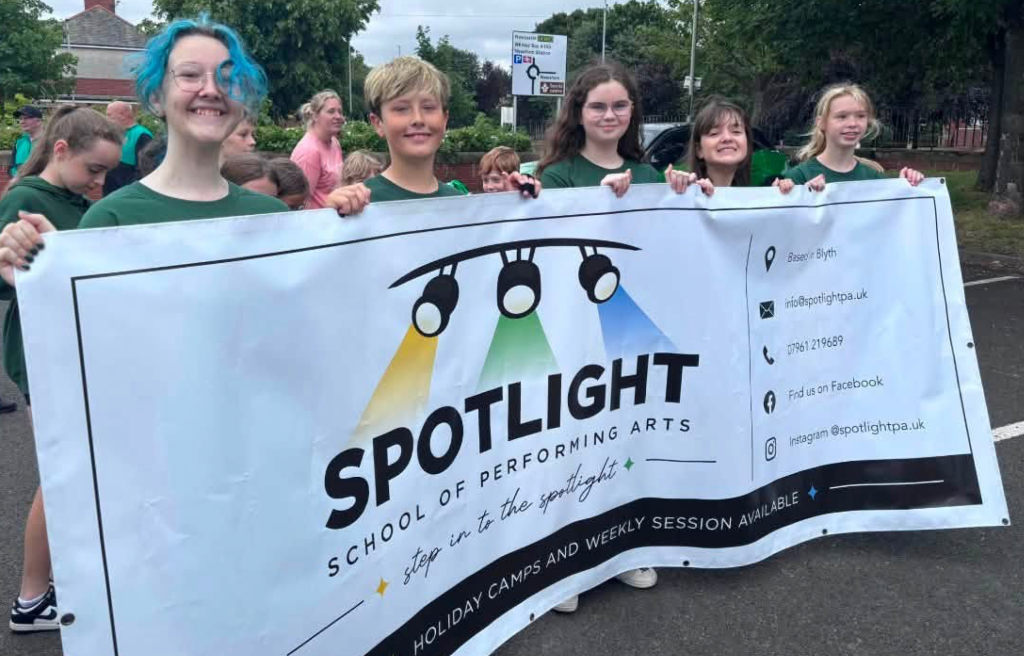 Students holding the Spotlight School banner