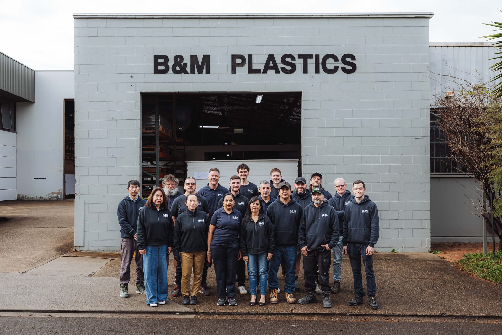 The B&M Plastics team of 18 standing outside the Yennora workshop