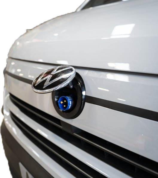 Van-Plug installed behind VW badge showing the blue 240V socket