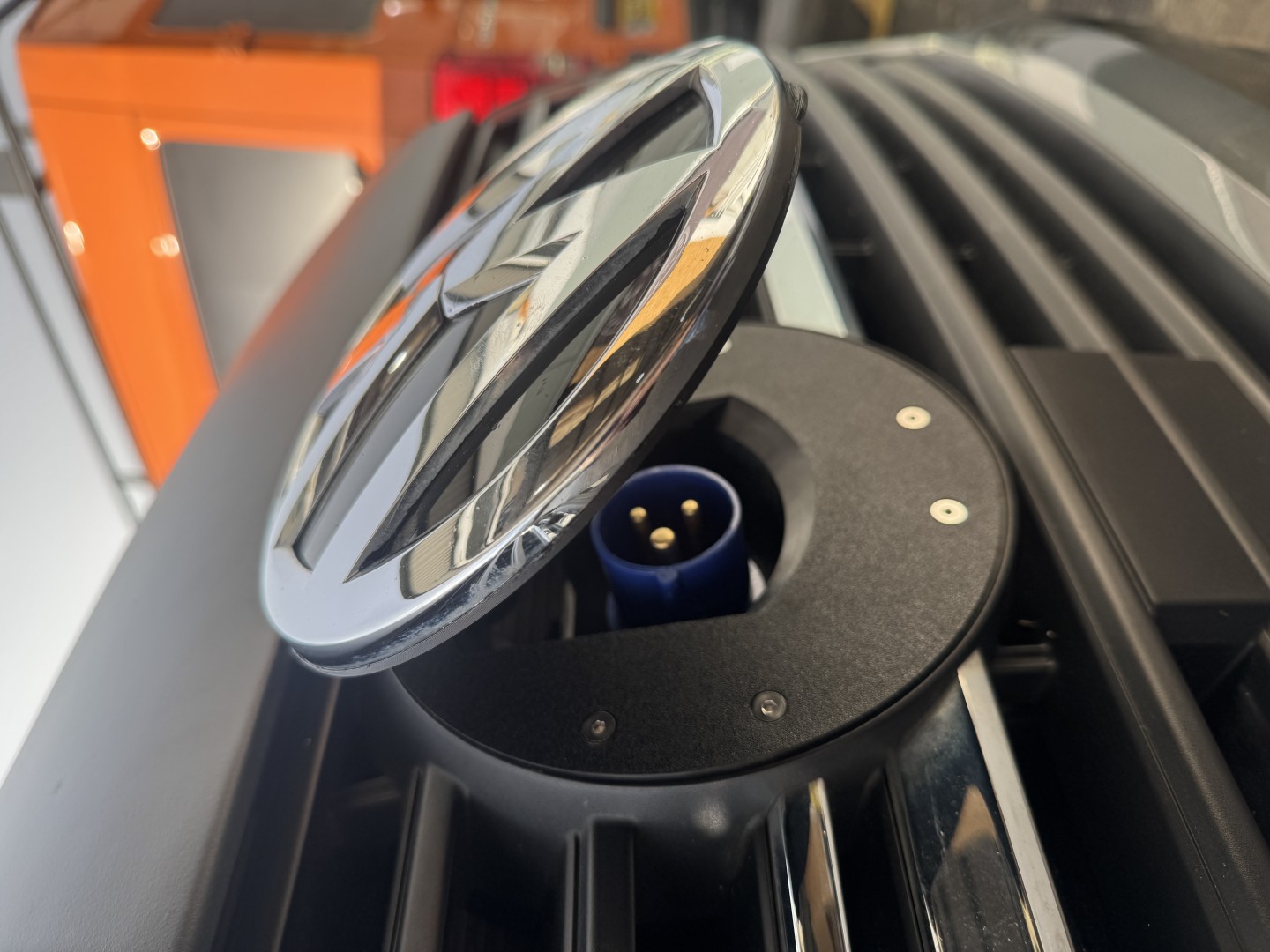 VW charging port with open emblem