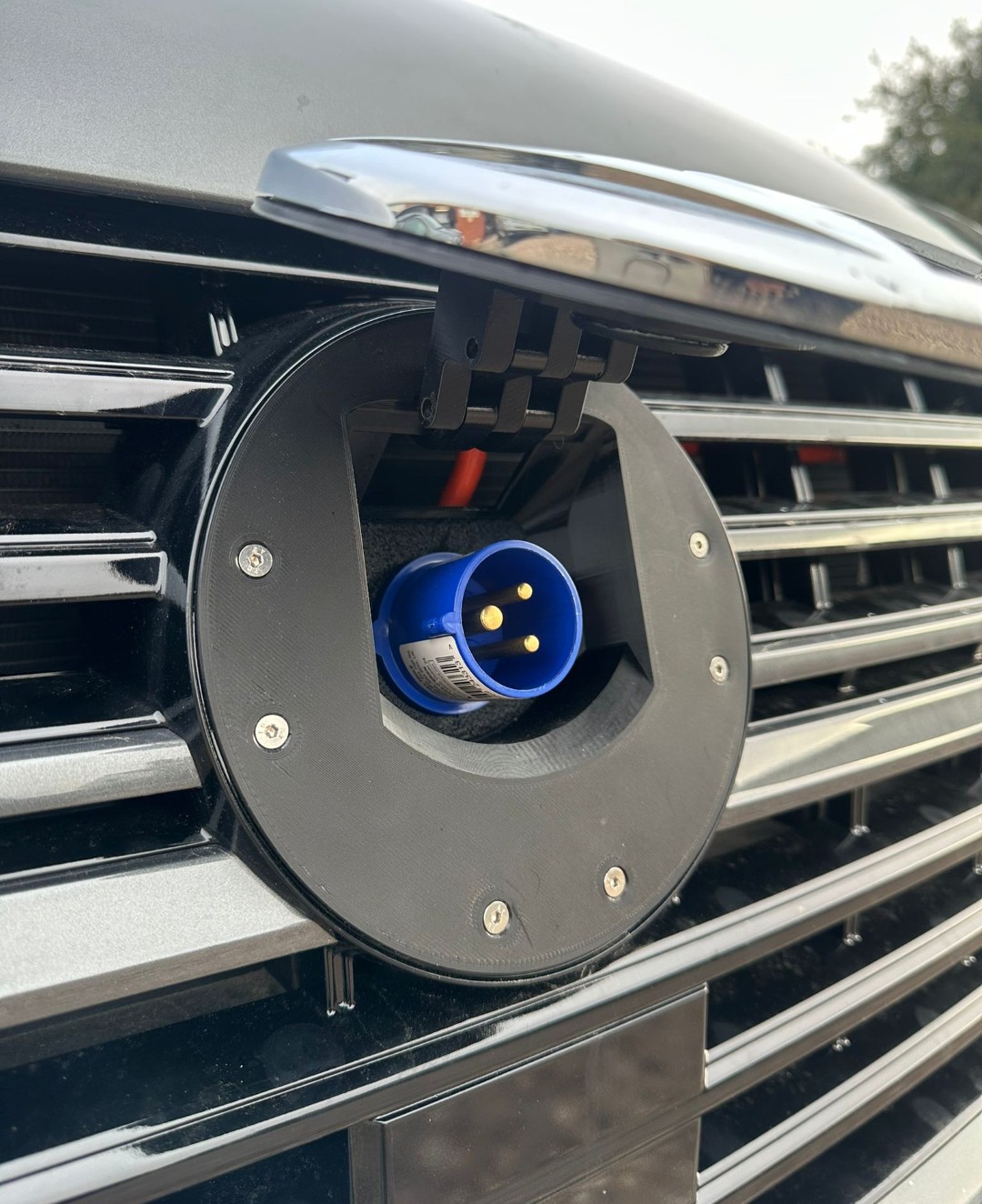 VW emblem open revealing blue socket