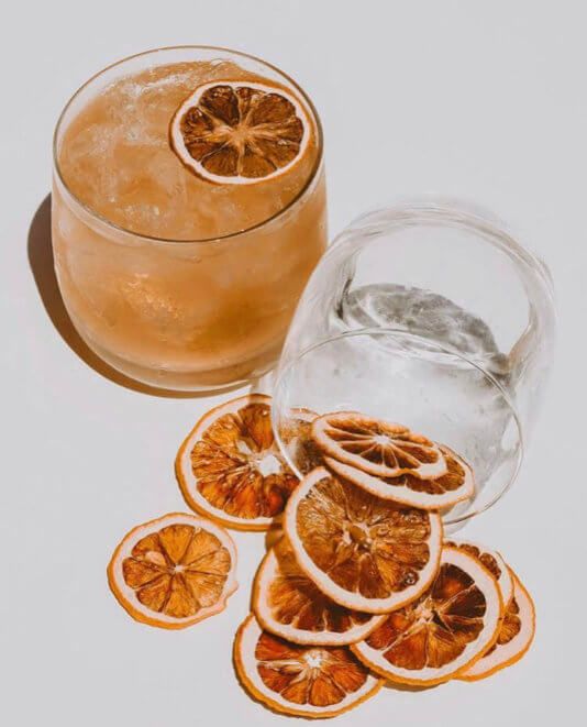 Top-down flat lay of HIYO mocktail glassware and dried citrus