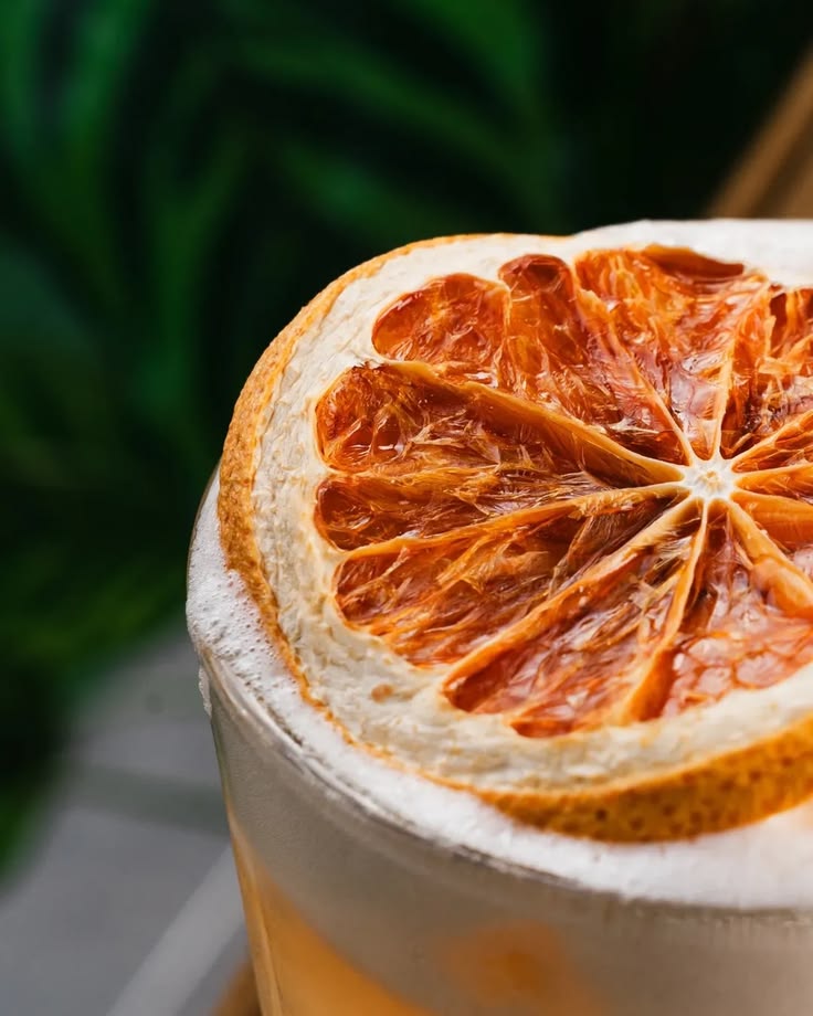 Macro close-up of a HIYO mocktail garnished with a dehydrated citrus wheel