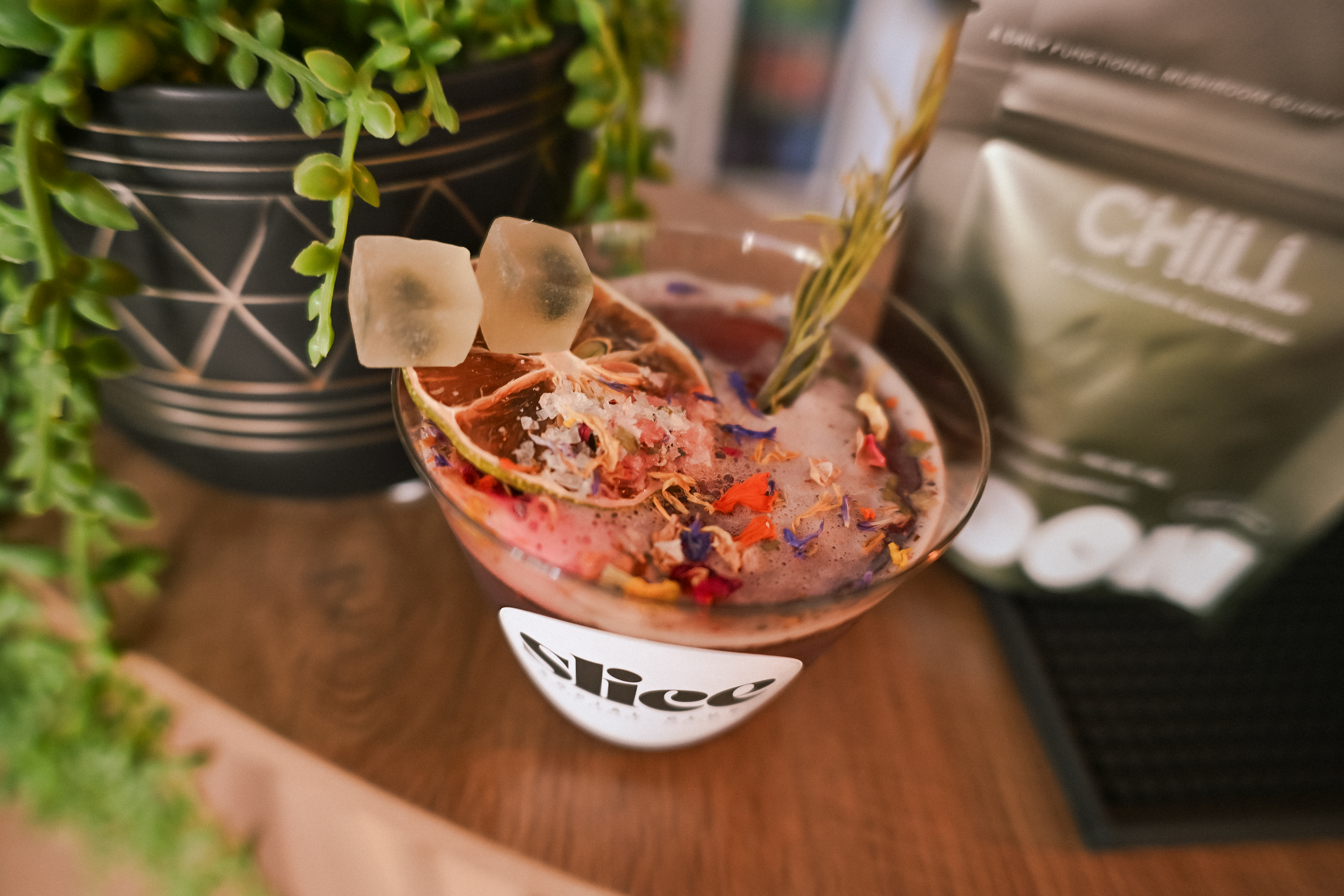 Slice Social Club mocktail with a CHILL functional mushroom gummy pouch