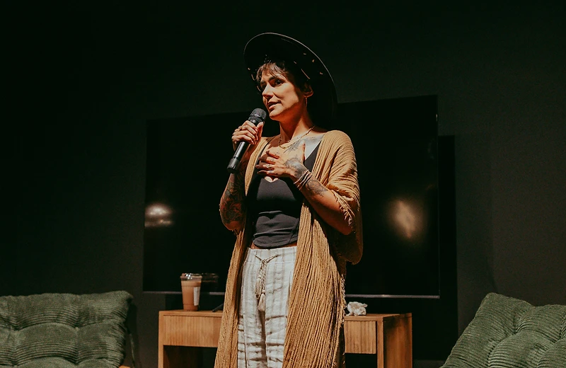 Nic speaking in a candlelit room