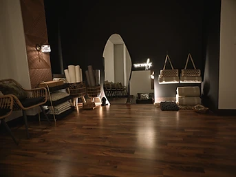 The Still Lounge — rattan chair, gold shelving, organic mirror, and 'time to fly' neon