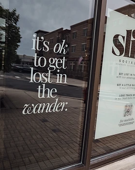 Slice Social Club window with branding and signage