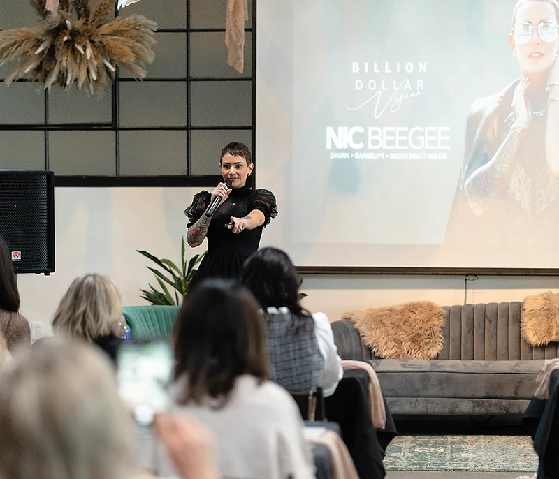 Nic speaking on stage at Billion Dollar Vision