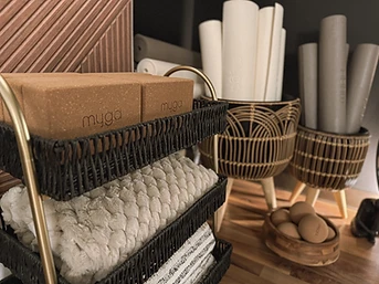 Cork blocks, rolled yoga mats, and a bowl of massage balls