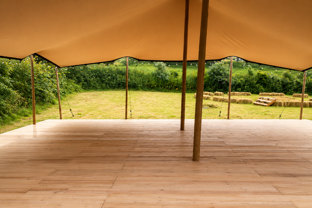 Plancher en bois installé sous une tente stretch ouverte sur le jardin