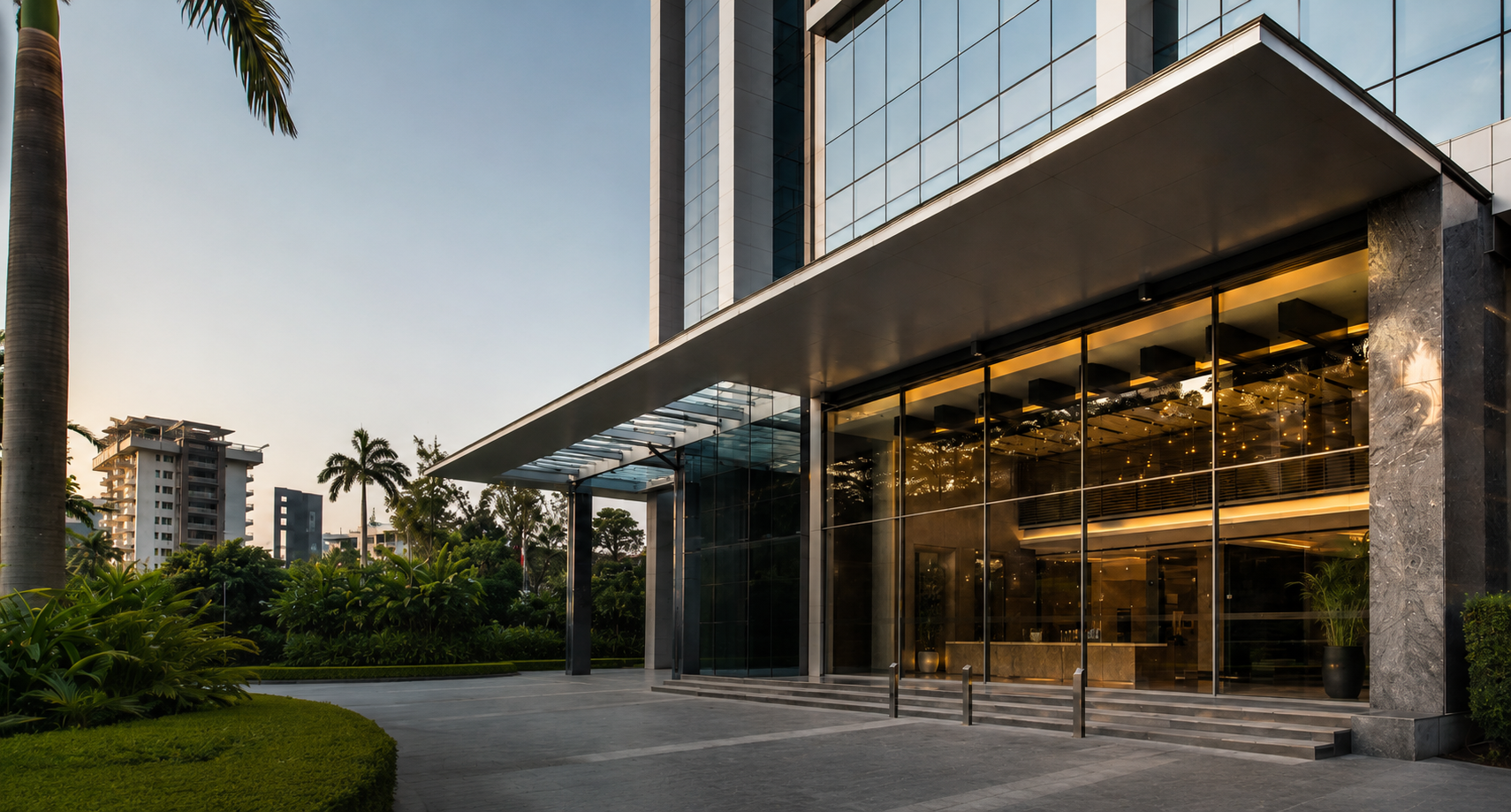 Illuminated glass commercial building entrance at dusk