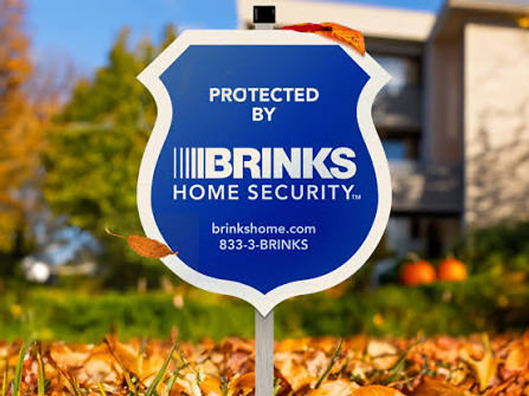Brinks Home Security yard sign posted in a residential yard
