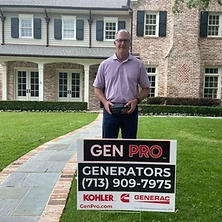 Senior man holding Generac generator remote with A&A GenPro installed sign at Texas home