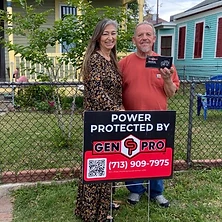 Satisfied homeowner with thumbs up by A&A GenPro power protected sign at Houston Texas home