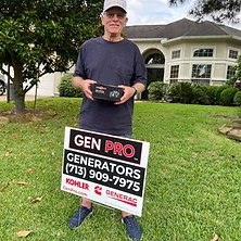Woman holding emergency radio next to A&A GenPro installation sign at Houston home