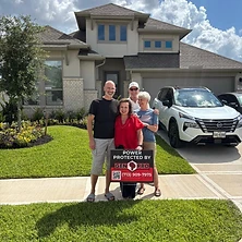 Man holding Generac remote controller with Gen Pro Generators sign at Houston Texas home