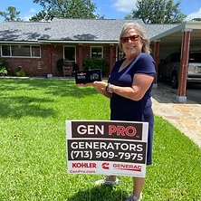 Woman holding A&A GenPro emergency radio next to generator installation sign at Houston Texas home