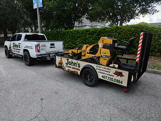 John's Stump Grinding truck and trailer with Vermeer SC30TX stump grinder — compact rig for residential and tight-space access in Oviedo, FL