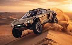 A desert machine cresting the dunes at dusk