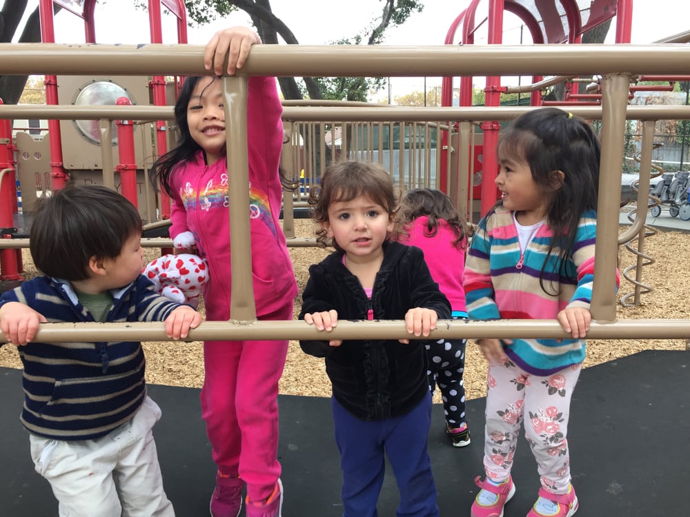 Children climbing on the outdoor playground structure