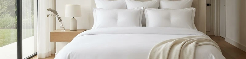Perfectly made luxury bed with crisp white linens, Serene Sparkle bespoke cleaning in Henderson