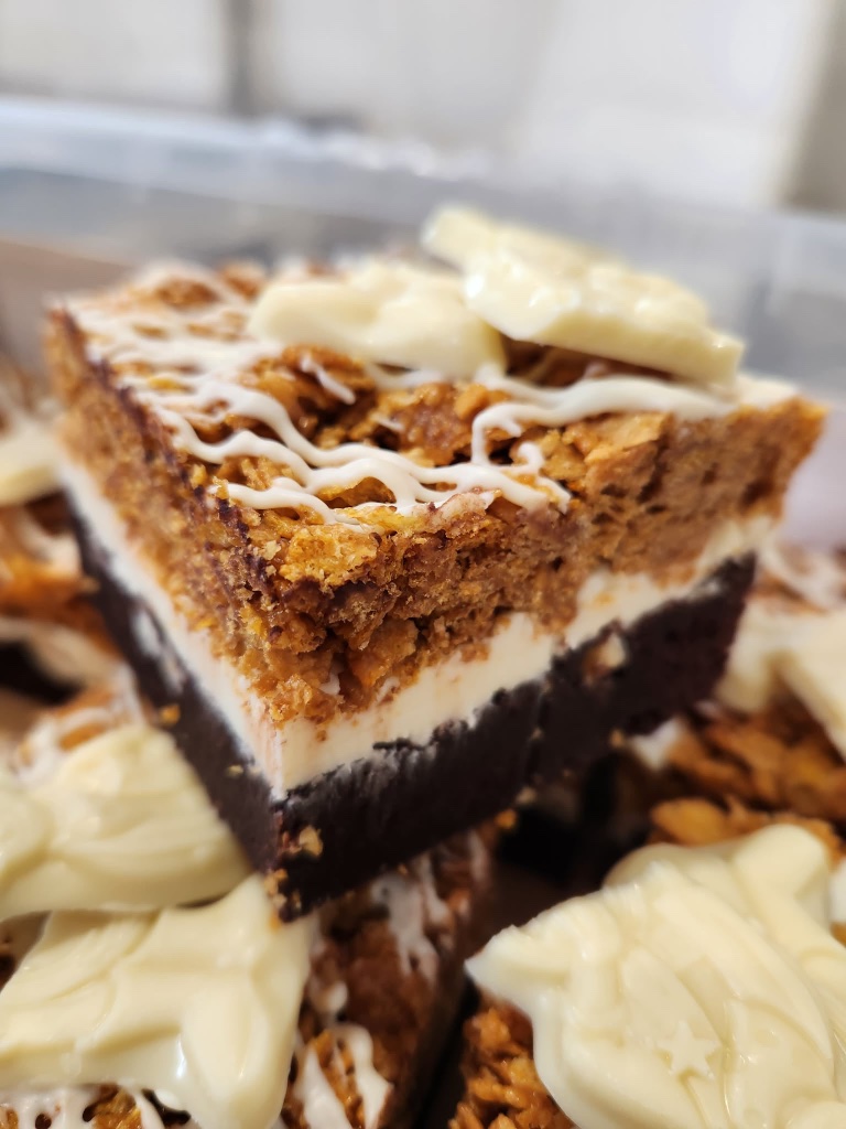 Milky bar caramel cornflake brownie with white chocolate and cornflake topping