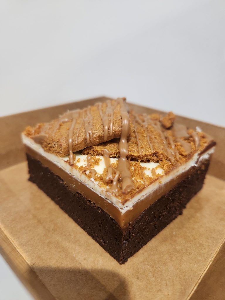 Biscoff millionaire brownie with caramel and biscuit crumble