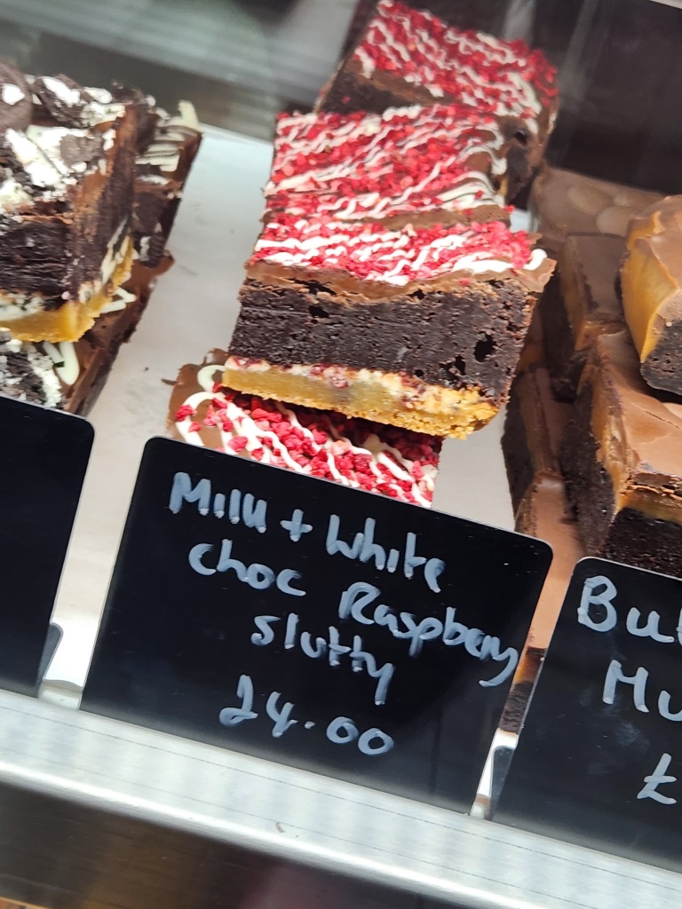 Milk and white chocolate raspberry slutty brownie with freeze-dried raspberry crumbles
