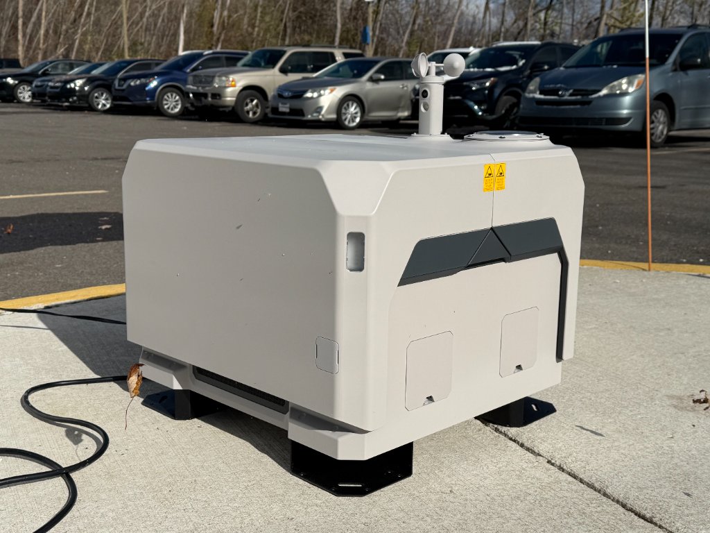 Dock-based enterprise drone system positioned inside an active automotive facility.