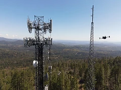 Infrastructure towers with a drone operating nearby.