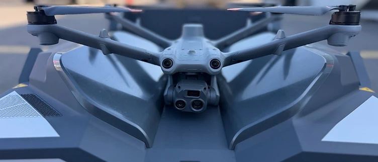 A professional camera drone resting on field equipment.