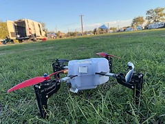 An experimental multirotor aircraft positioned on grass.