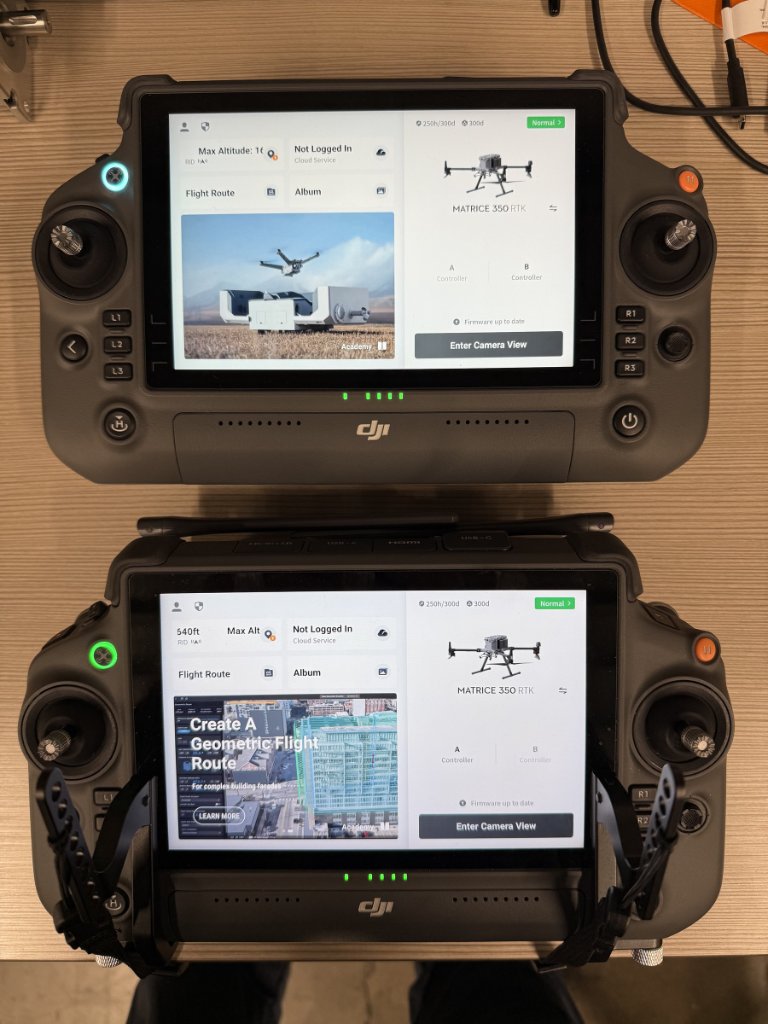 Two enterprise drone controllers powered on during aircraft and system readiness checks.