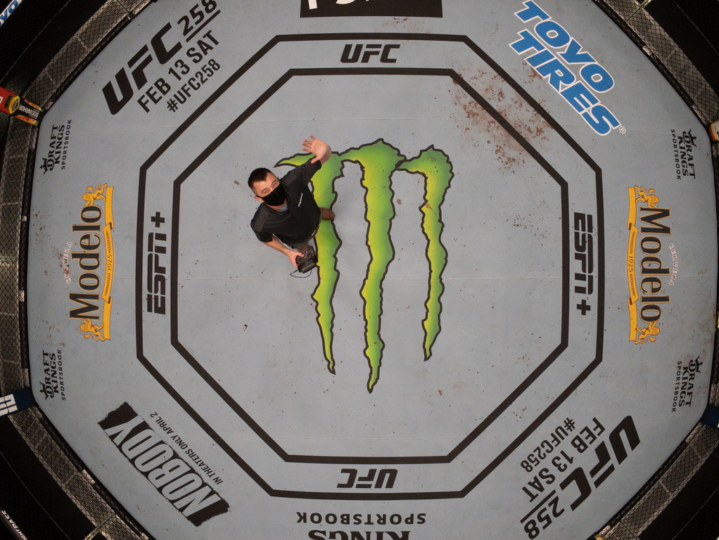 Overhead aerial view inside a UFC octagon during production activity.
