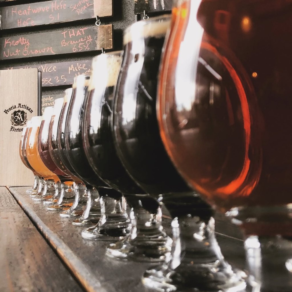 A flight lineup of house-brewed beers on the gastropub bar at Peoria Artisan Brewery