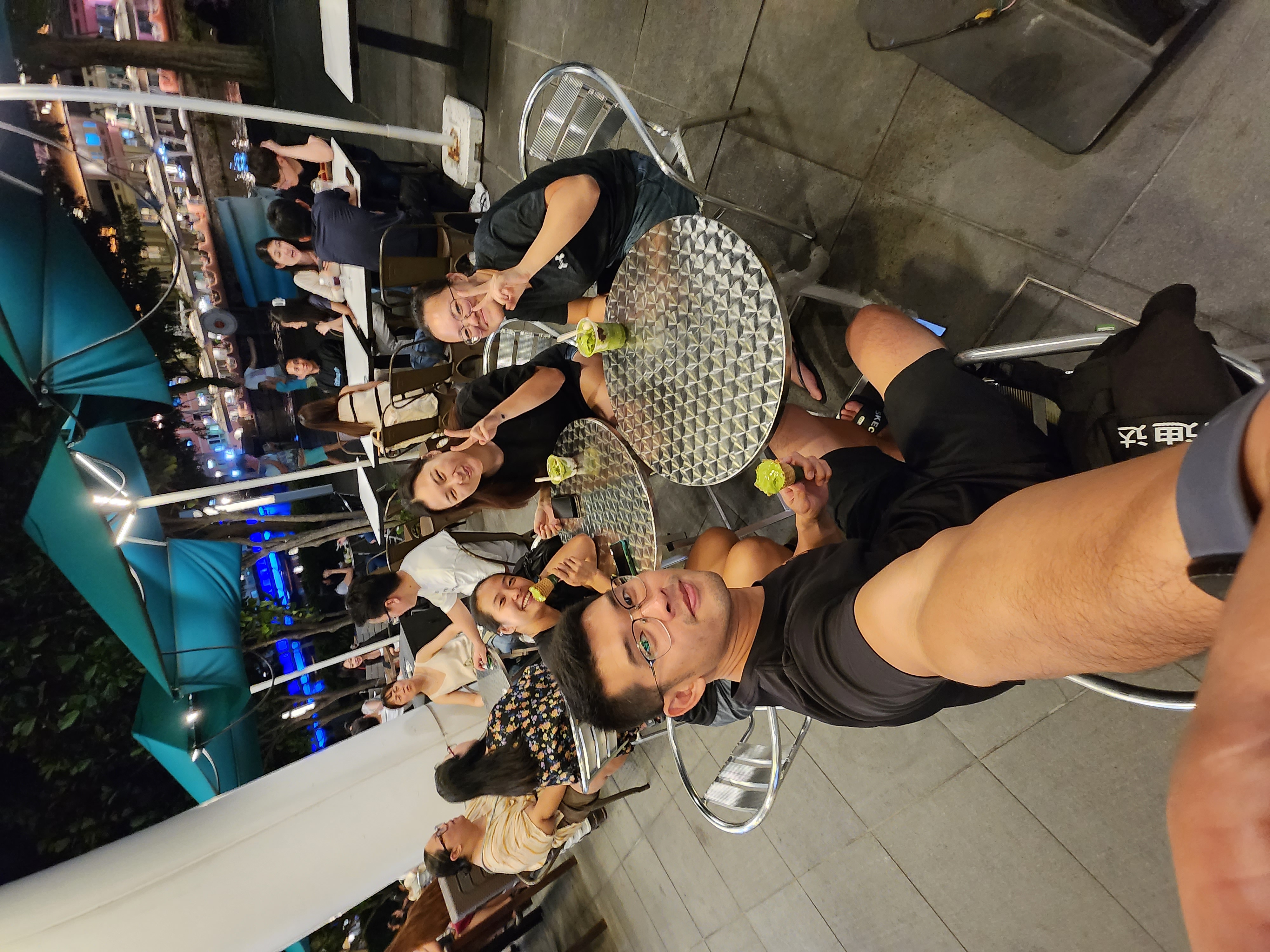 Friends sharing ice cream at an outdoor table after an evening session
