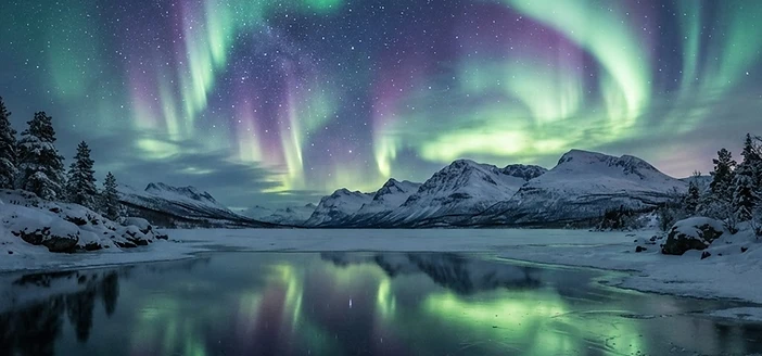 Aurora borealis ribbons of green and violet over a starlit Arctic sky