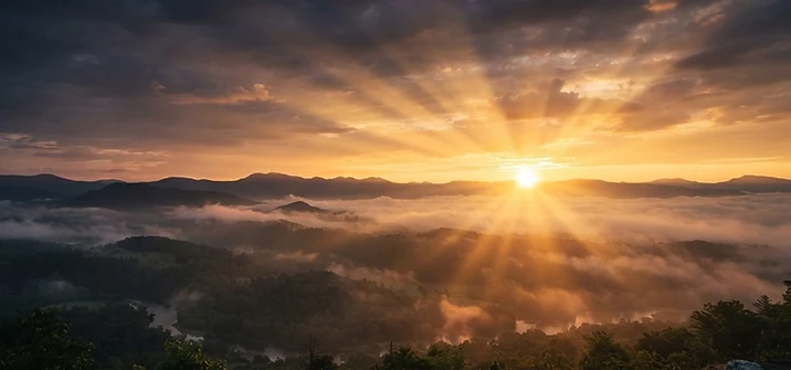 Golden sunrise breaking over a misty eastern horizon
