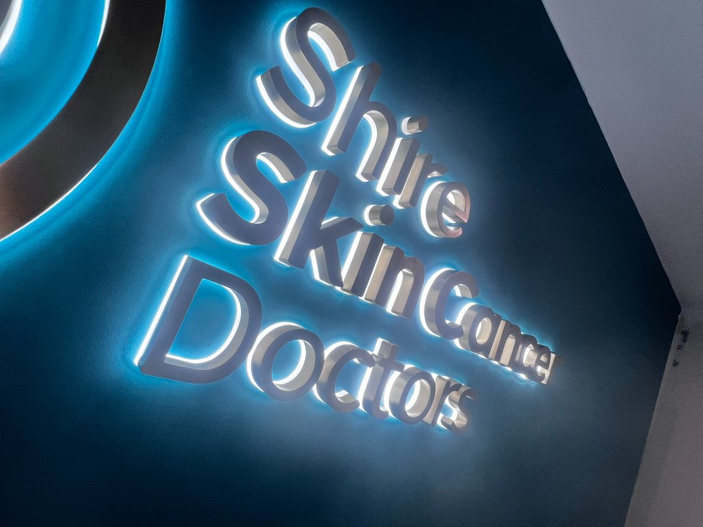 Shire Skin Cancer Doctors — photo 4: Halo-Illuminated 3D Logo, Brushed Bronze Lettering, Consult Room Wayfinding, Wall Signage