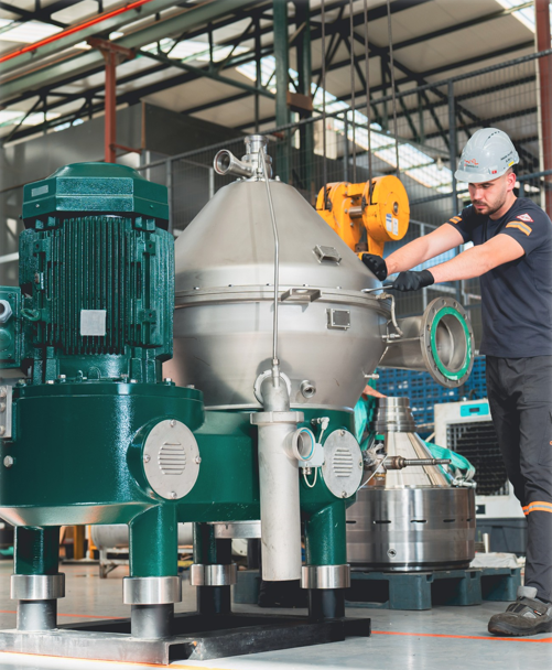 Field service engineer working on a decanter separator machine