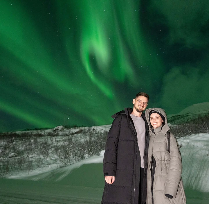 Guests under the Aurora Borealis — part of your Tromsø Pure journey