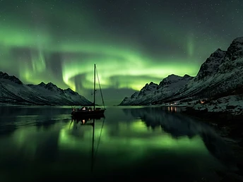 Chase the aurora from the water, away from city lights, on your own private vessel.