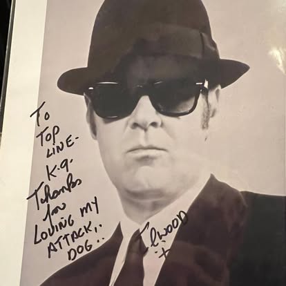 Autographed black-and-white portrait of Dan Aykroyd as Elwood Blues, inscribed to Top Line K9 with thanks for loving his attack dog.