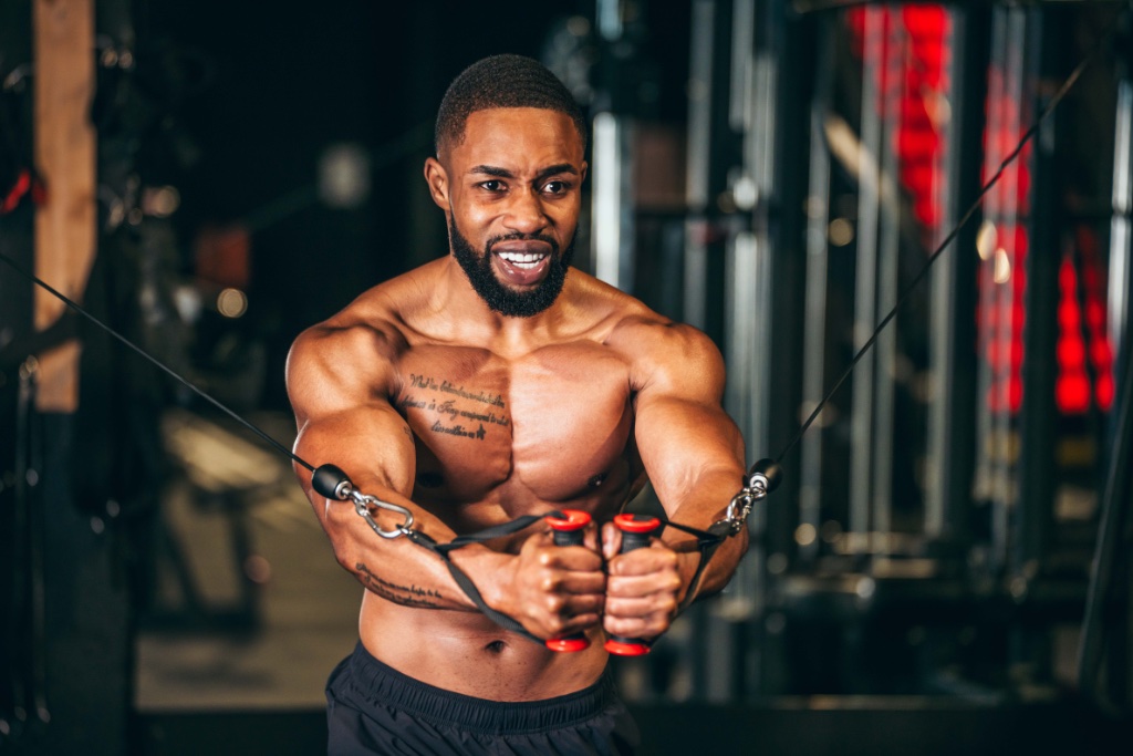 Athlete performing cable chest fly with intense focus