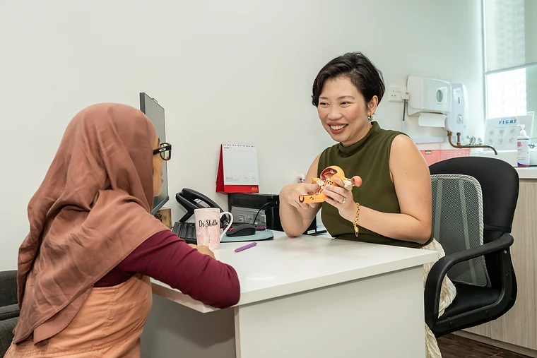 Dr Shilla Mariah explaining women's reproductive health during a consultation