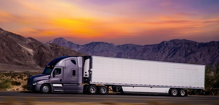 Refrigerated truck on the highway at sunrise