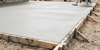 Freshly poured and finished concrete slab with smooth surface and clean formed edges